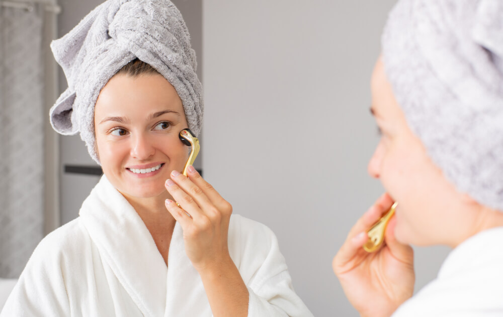 Woman using derma roller for loose skin