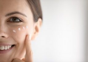 woman applying eye cream