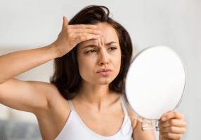 woman skincare concerned