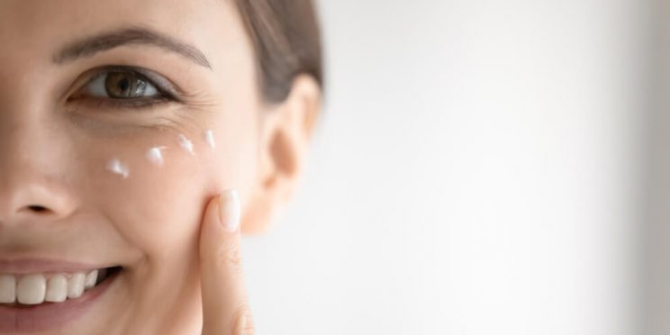 woman applying eye cream